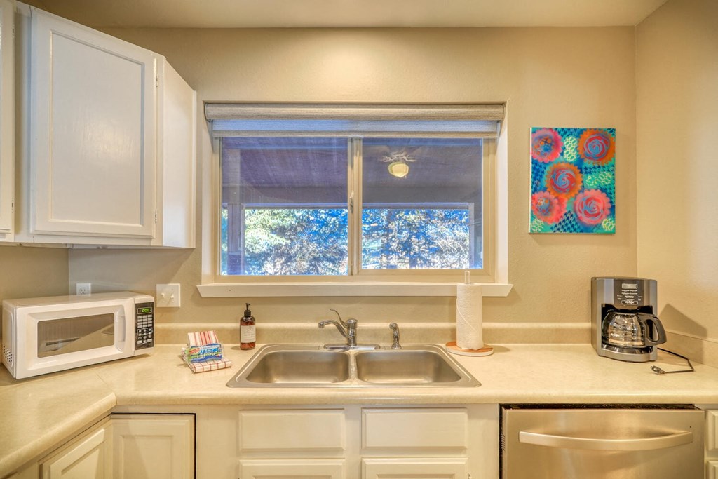 a kitchen with a sink and a window