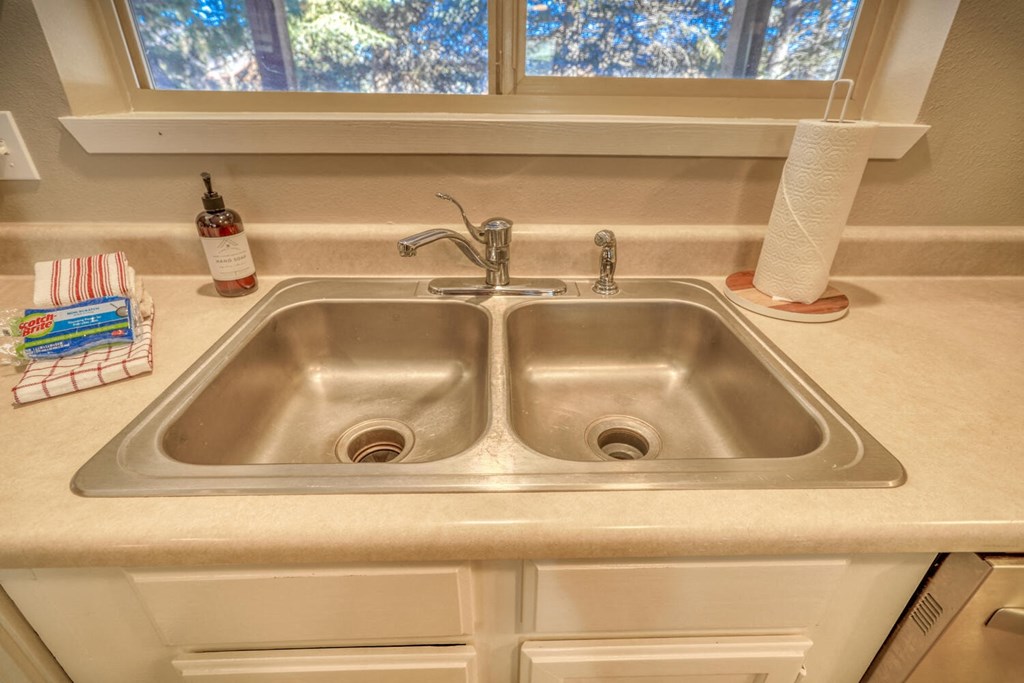 a kitchen sink with a window above it