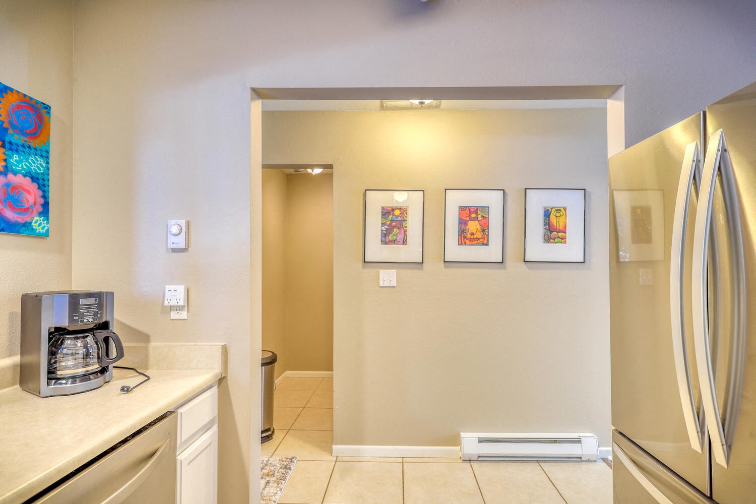 a kitchen with a coffee maker and a refrigerator