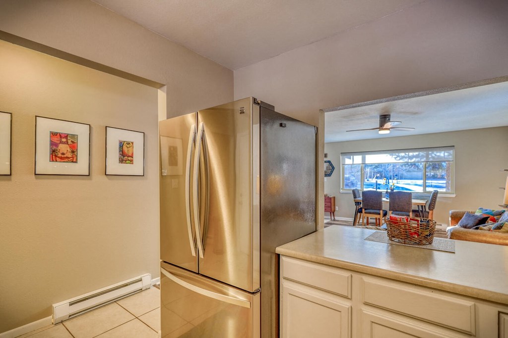 a kitchen with a stainless steel refrigerator and a counter top