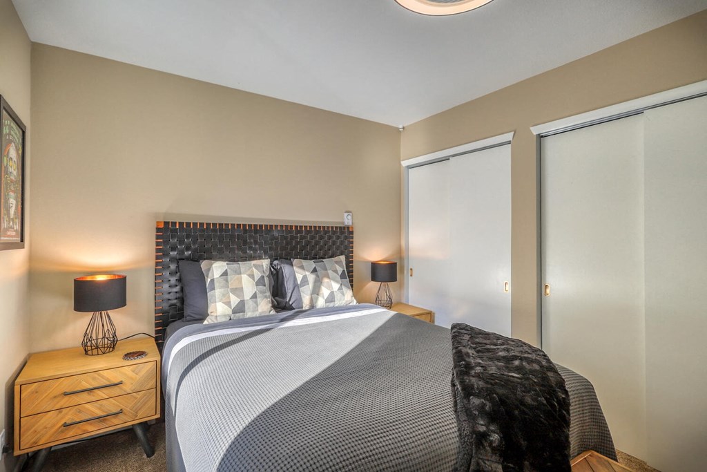 a bedroom with a large bed and a window