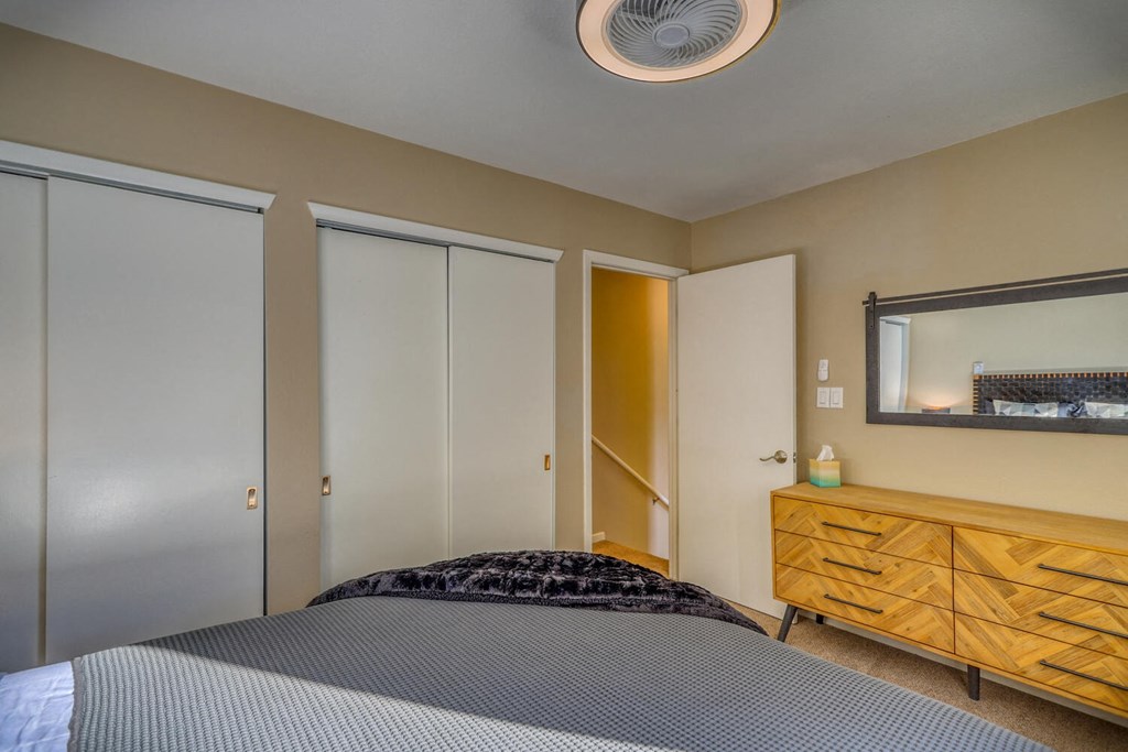 a bedroom with a bed and closet doors