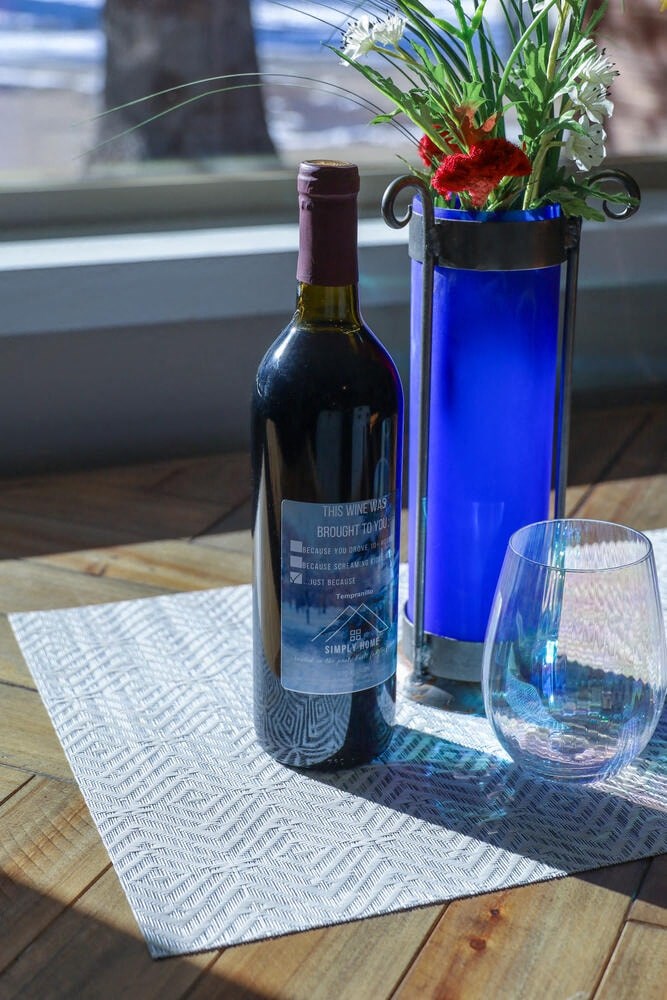 a bottle of wine and a glass on a table