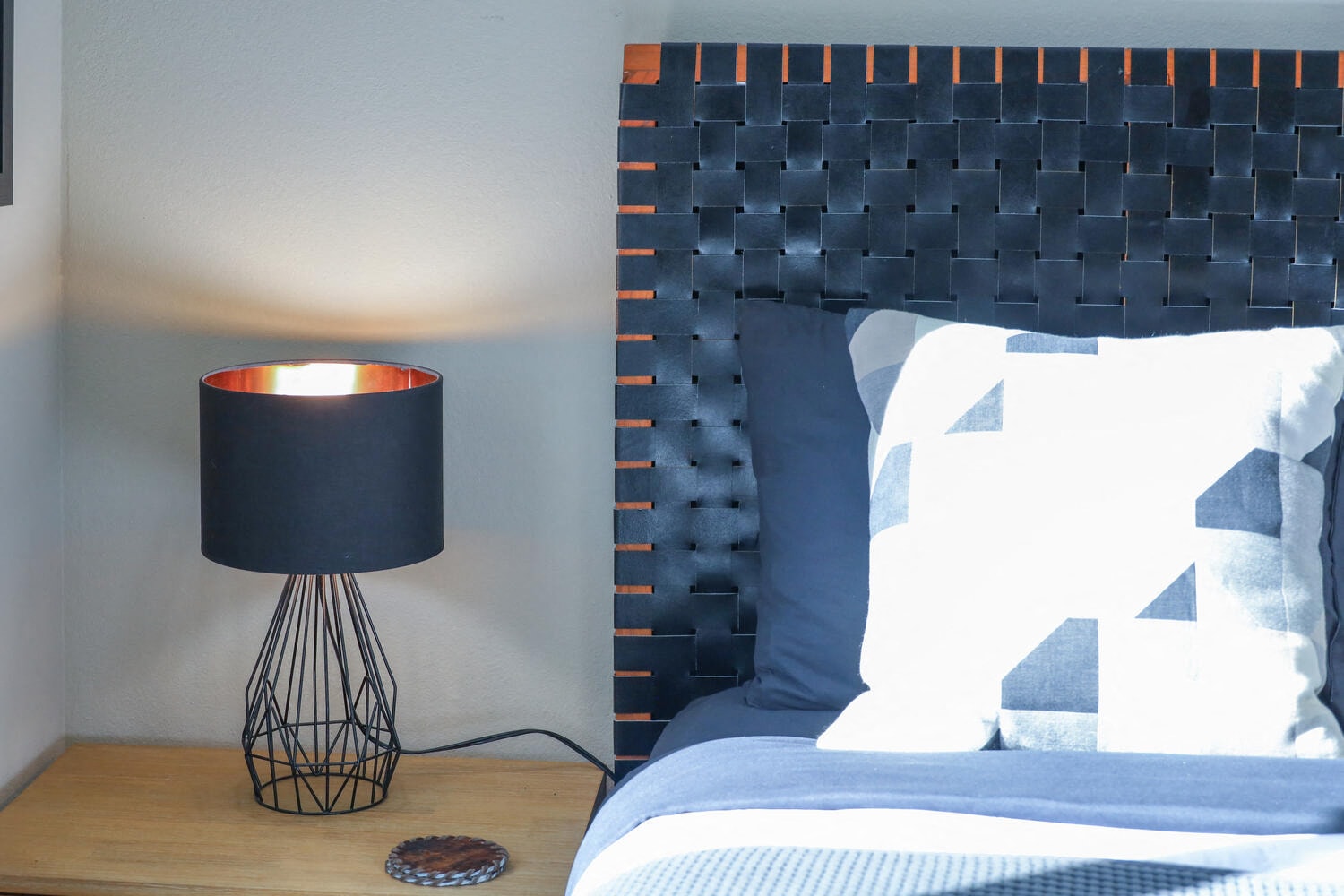 a bedroom with a bed and a lamp on a table