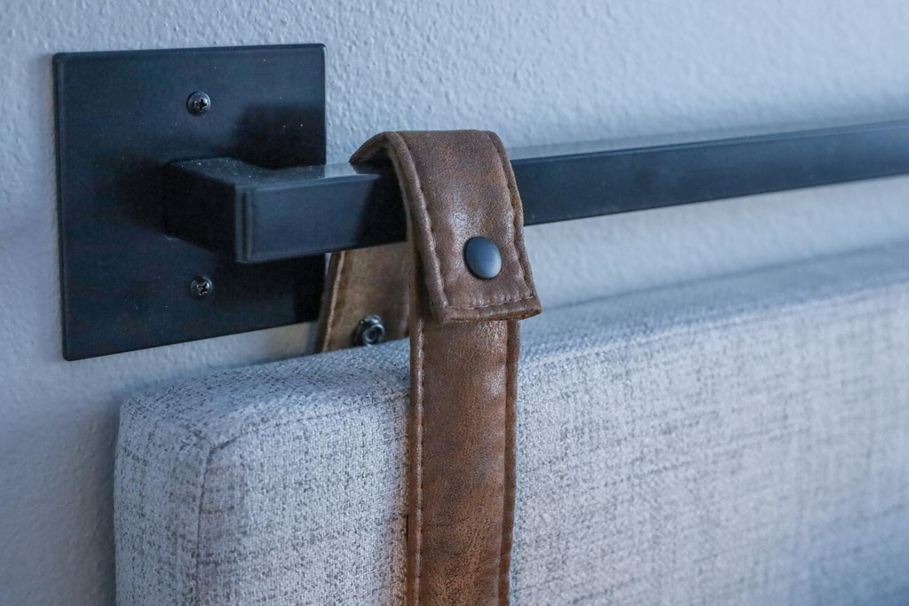 a leather strap holding up a blue couch
