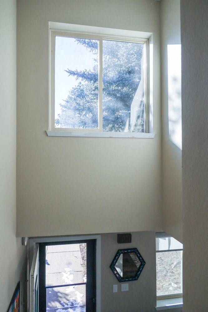 a view of a window above a refrigerator