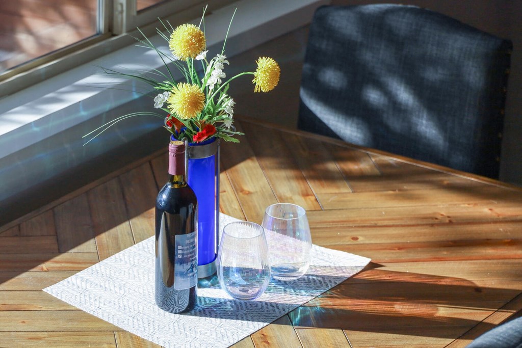 a bottle of wine and flowers on a table