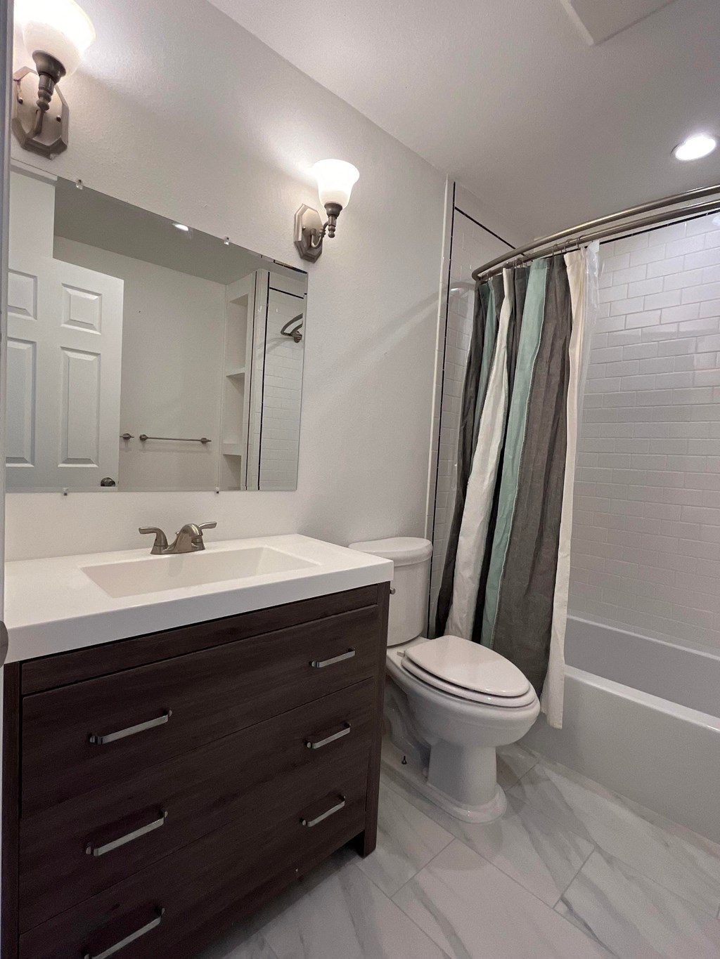 a bathroom with a sink and a toilet and a shower