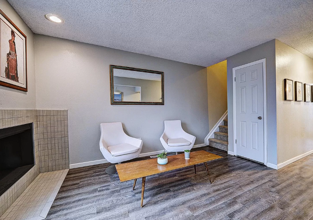 a living room with two chairs and a table