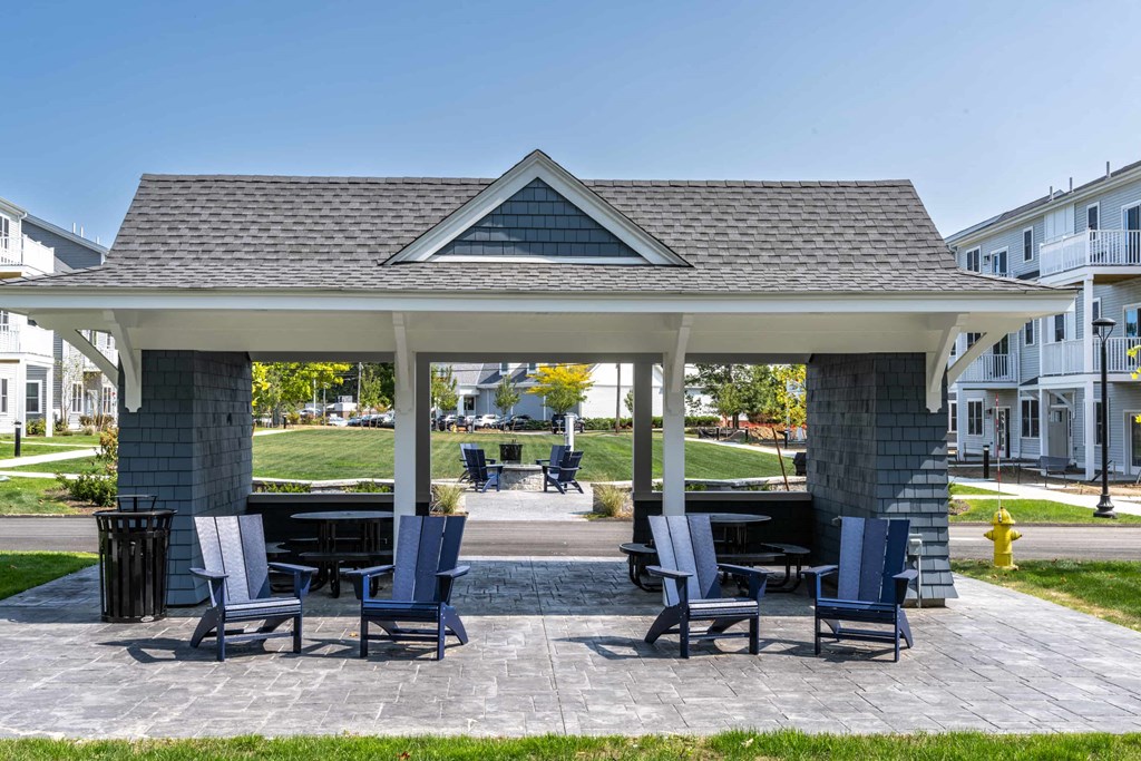 a gazebo with chairs and tables on a patio