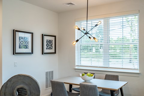 a dining room with a table and chairs and a chandelier