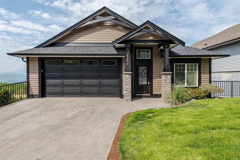 a house with a driveway and a garage door