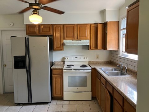 a kitchen with a stove refrigerator and a sink