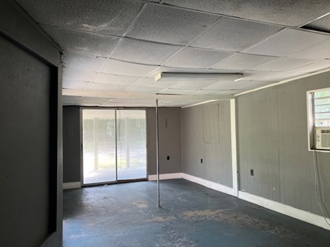 an empty room in a building with a glass door