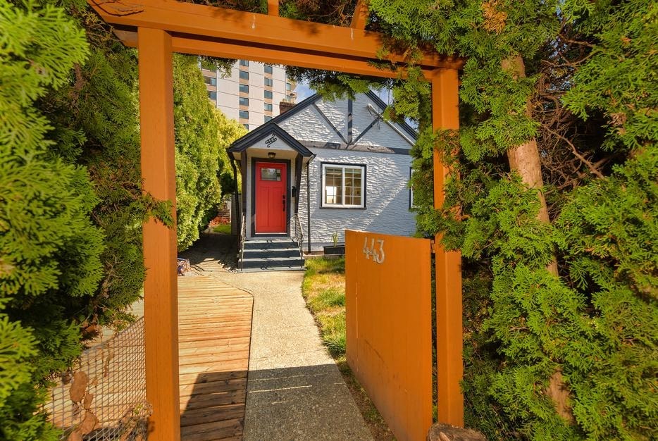 a small blue house with a red door