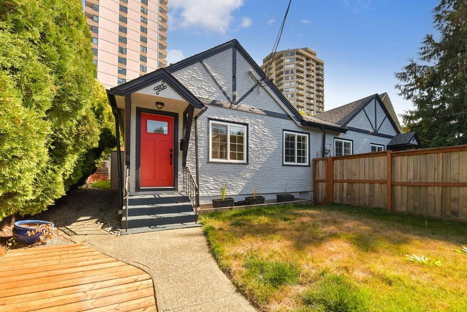 a small blue house with a red door