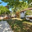 a backyard with a small house and a garden