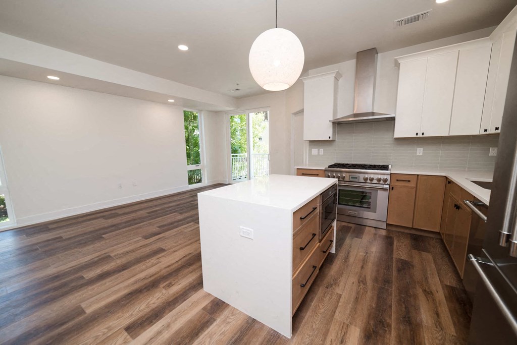 a large kitchen with a white island in the middle