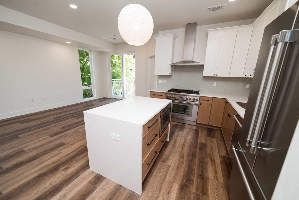 a large kitchen with a white island in the middle