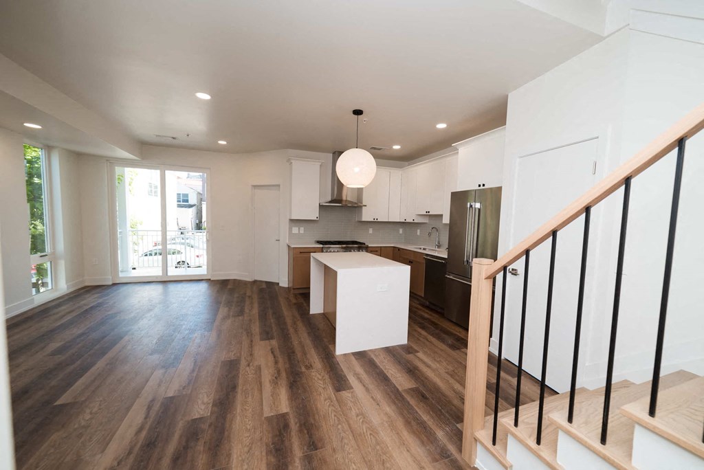a renovated living room and kitchen in a new home