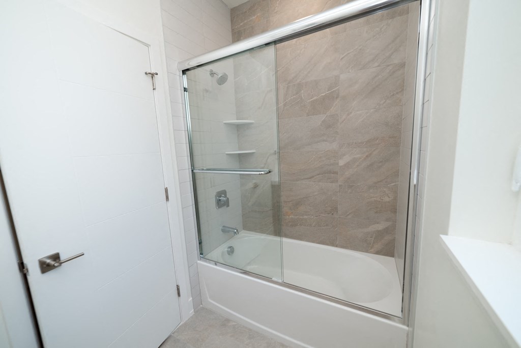 a small bathroom with a shower and a sink