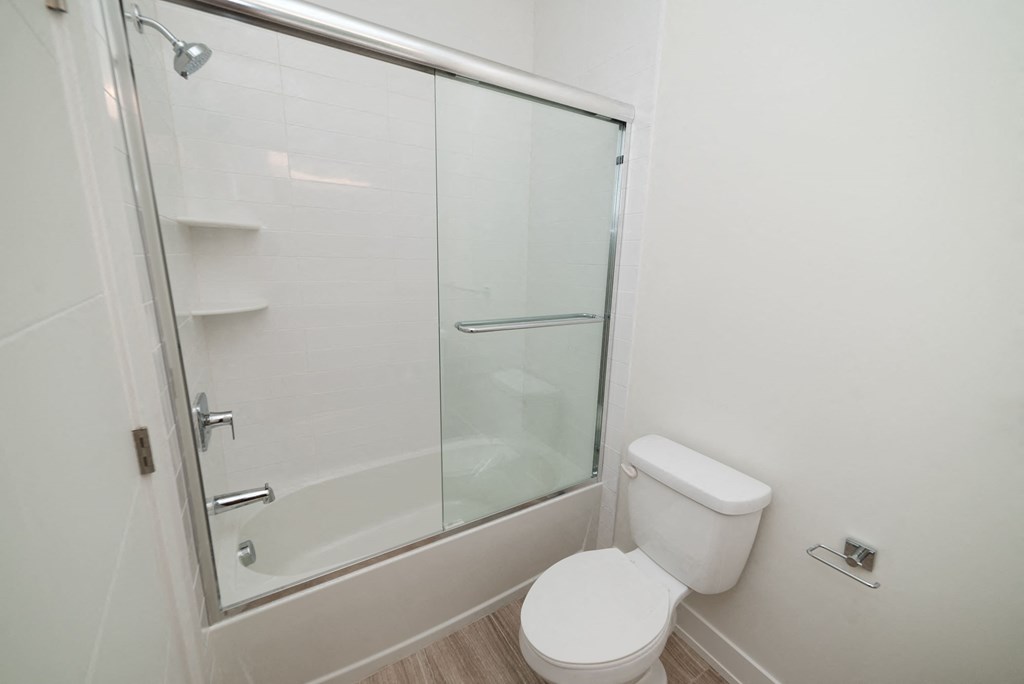 a small bathroom with a shower and a toilet
