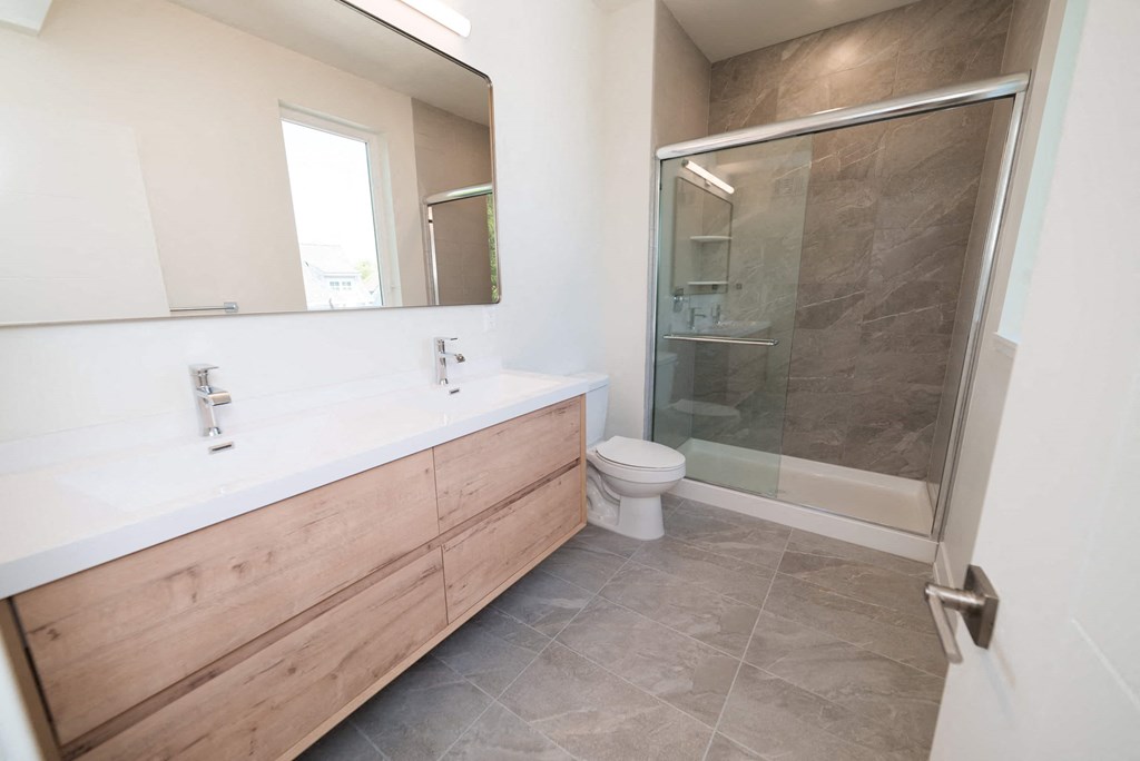 a bathroom with a toilet and a shower