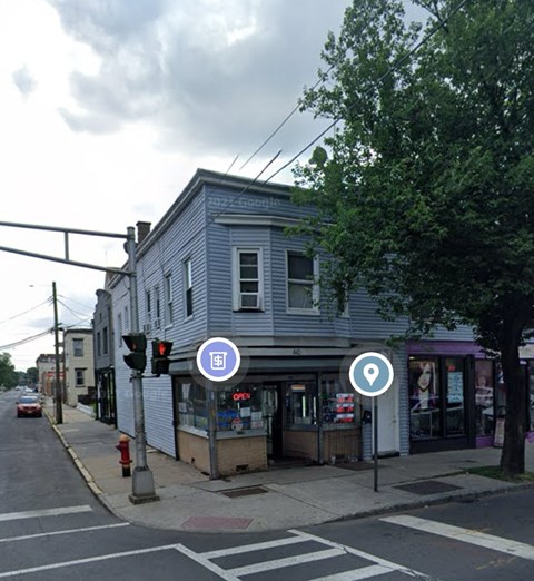 a gray building on the corner of a city street