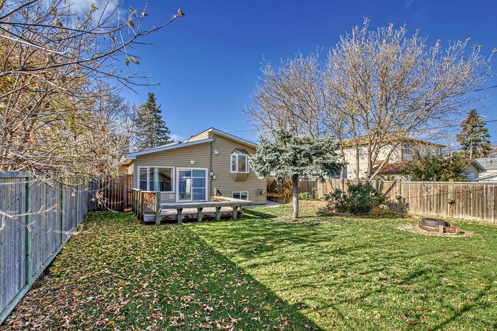 a small house with a yard and a fence