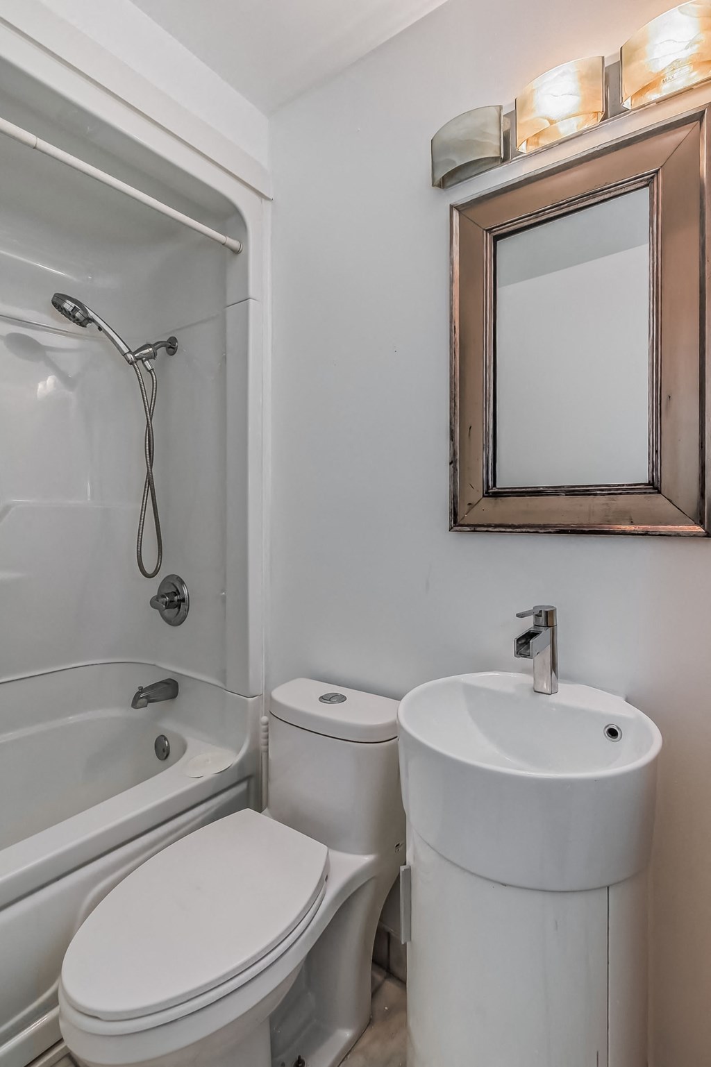 a small bathroom with a sink toilet and shower