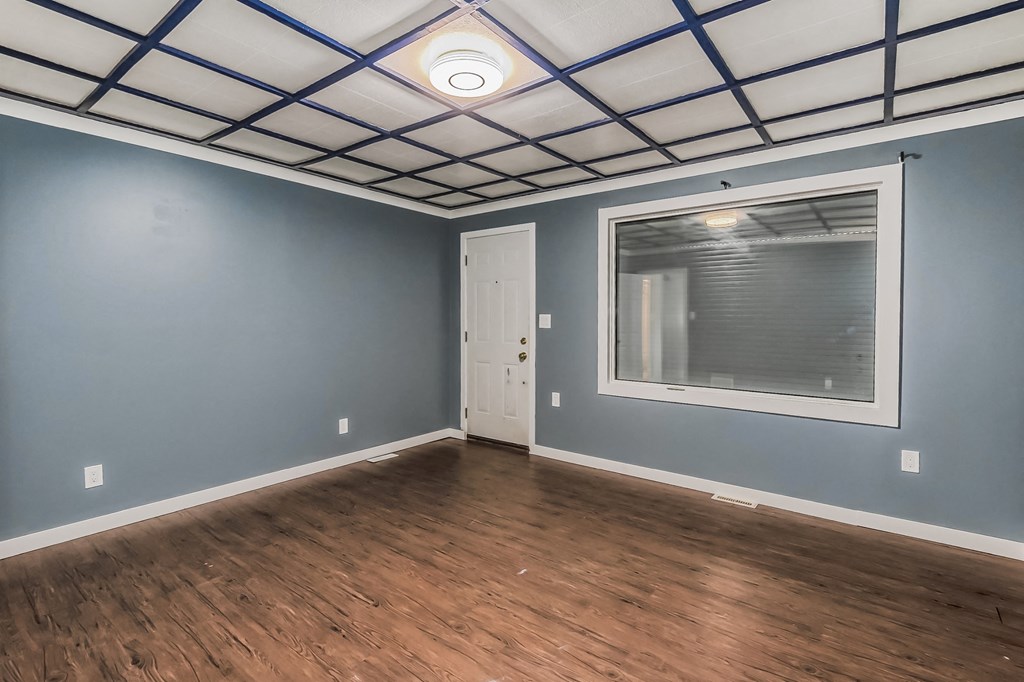 a living room with blue walls and a large window