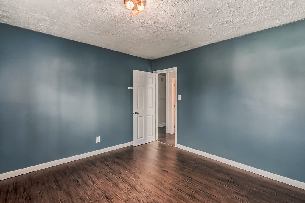 an empty room with blue walls and a white ceiling and a door