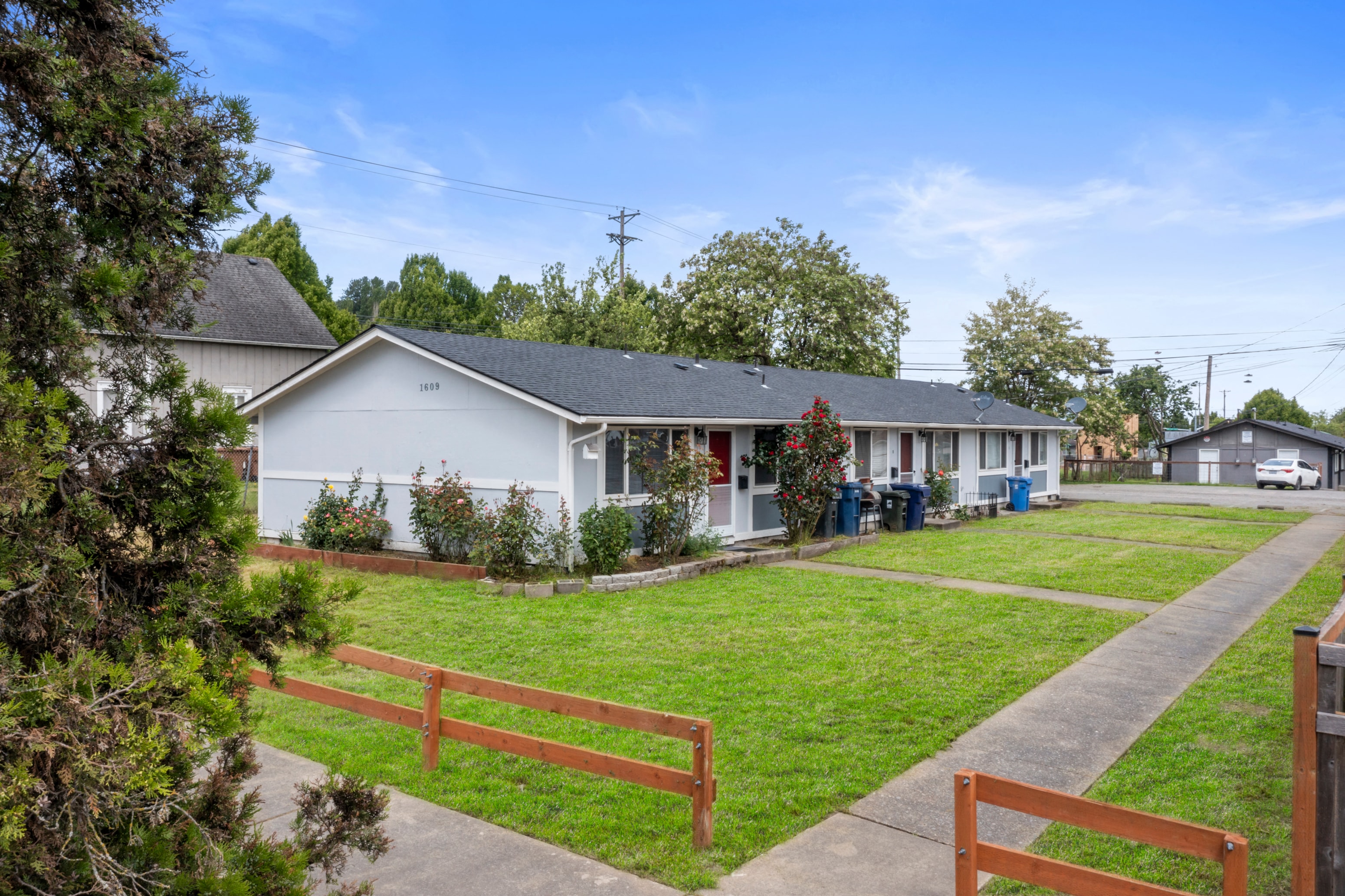 a white house with a yard in front of it