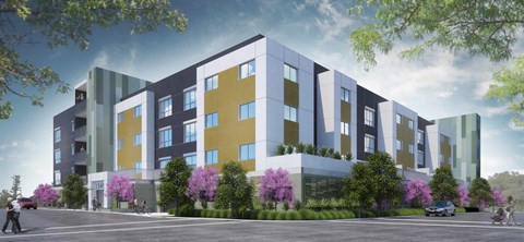 A modern multi-story building with a mix of yellow, blue, and grey panels.