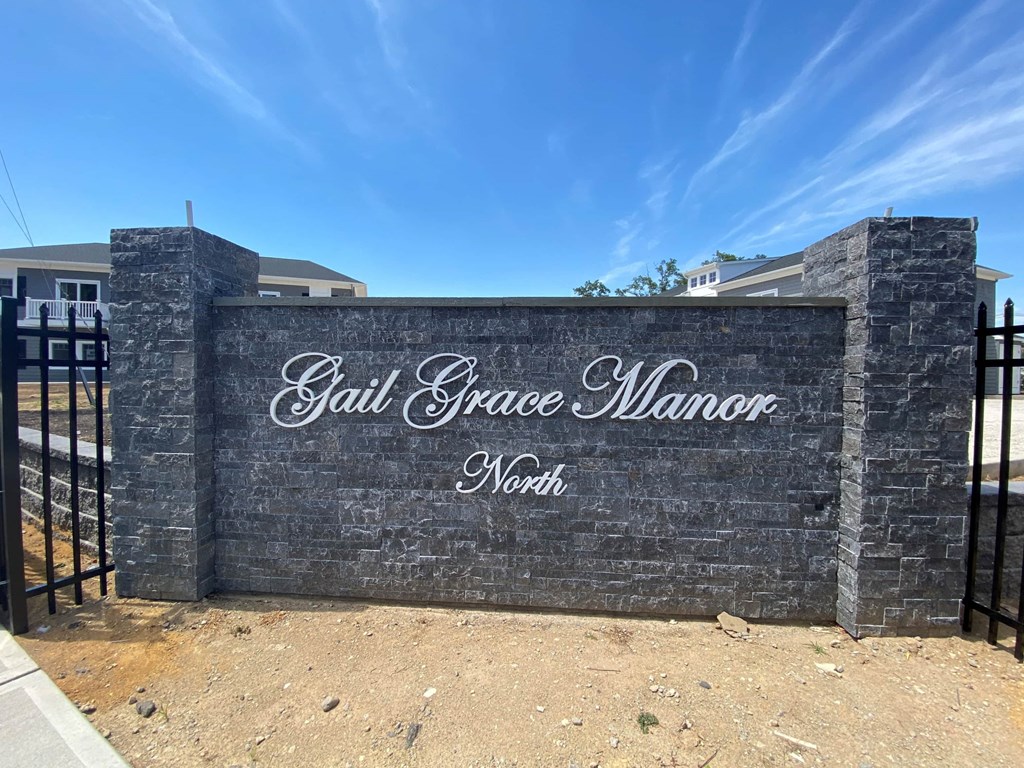 a sign in front of a fence