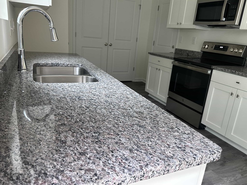 a kitchen with a granite counter top and a sink