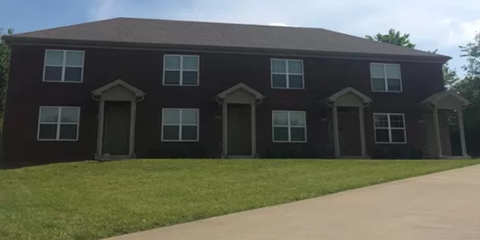 a house with a sidewalk and grass in front of it