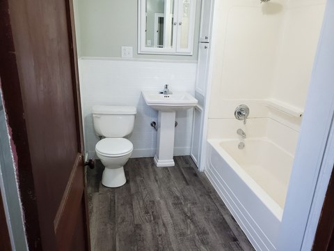 a small bathroom with a toilet sink and tub