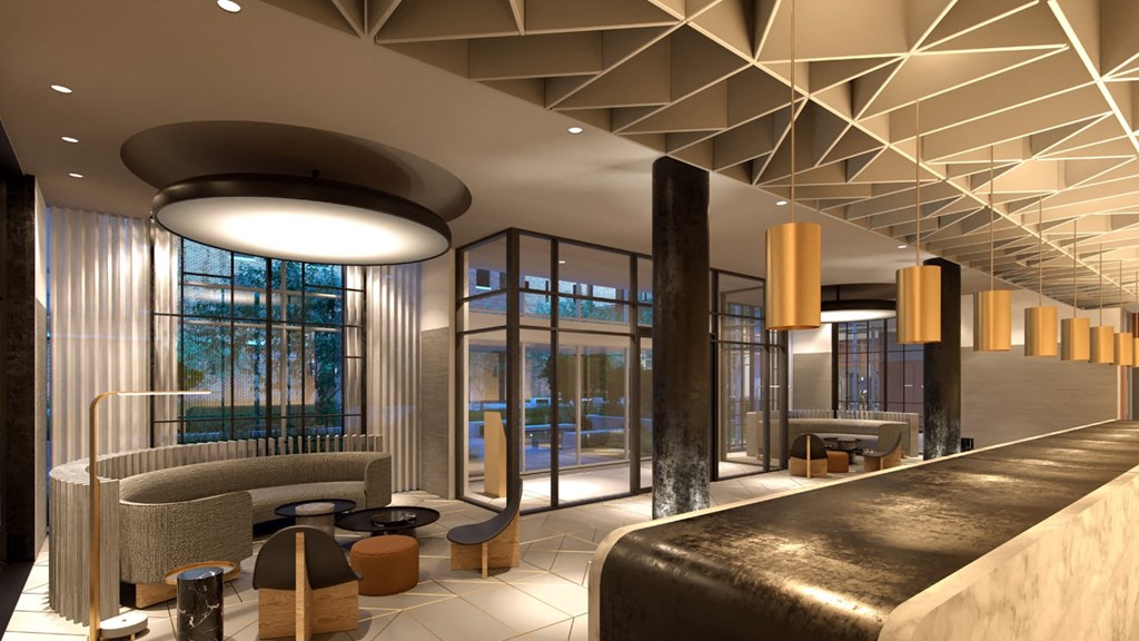 the lobby or reception area of a hotel with couches and chairs