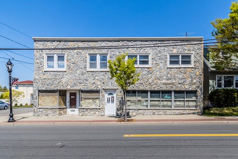 a stone building on the side of a street