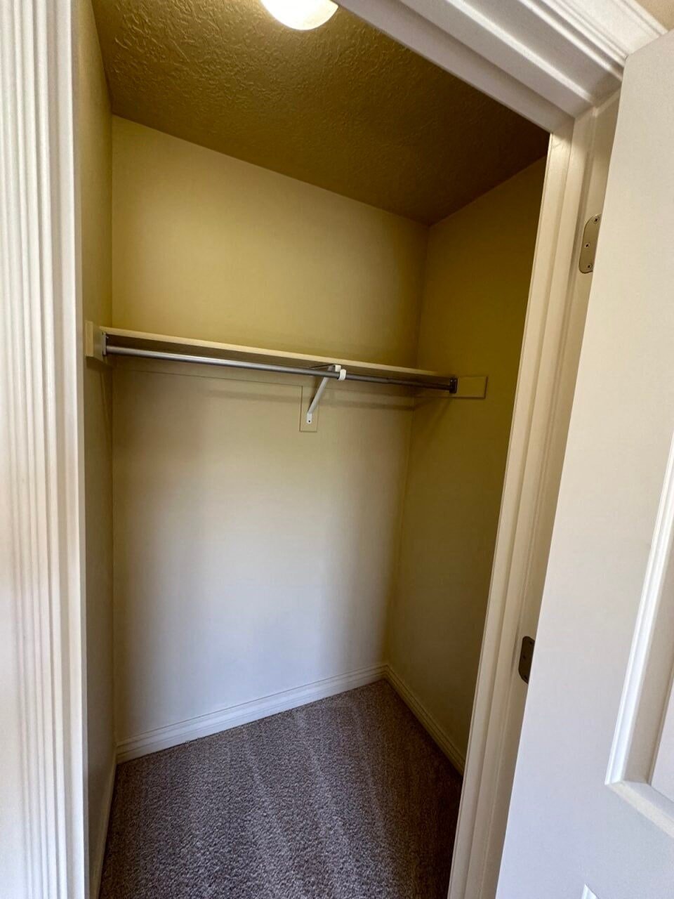 a empty closet with a hanging rail