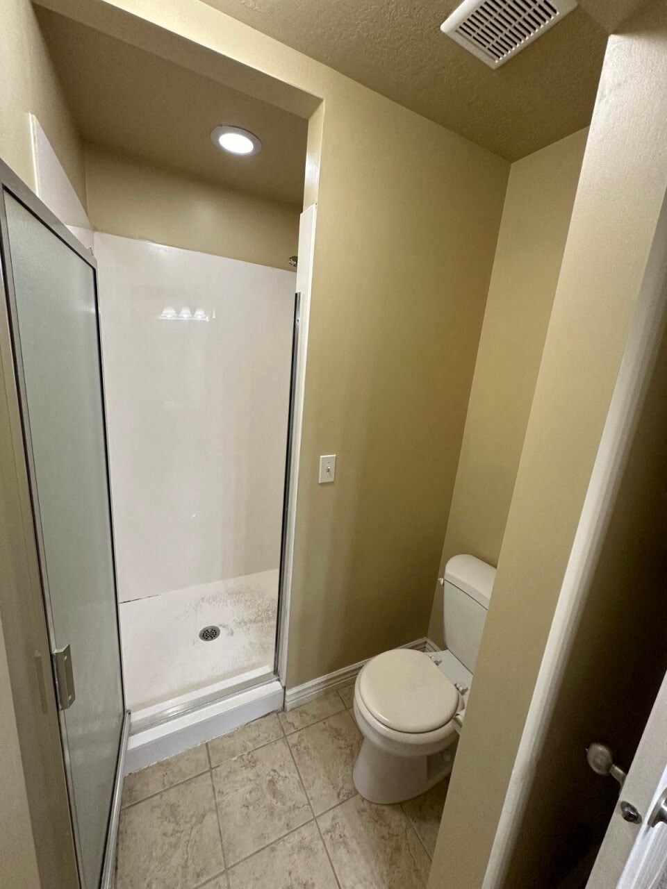 a small bathroom with a toilet and a shower