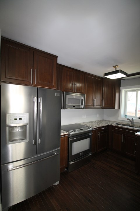 a kitchen with stainless steel appliances and wooden cabinets