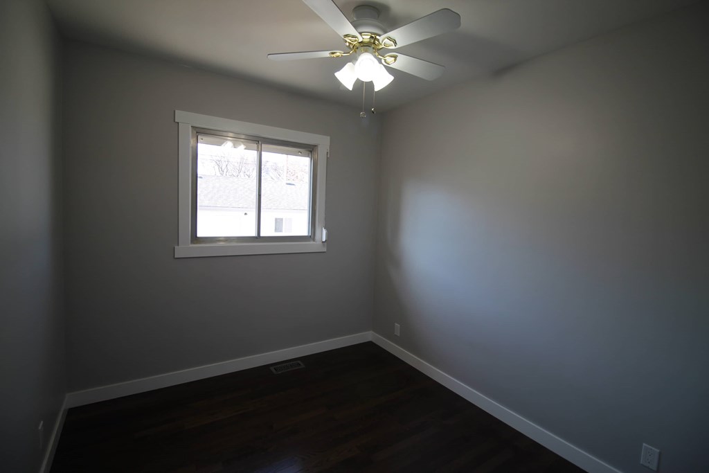 a room with a ceiling fan and a window
