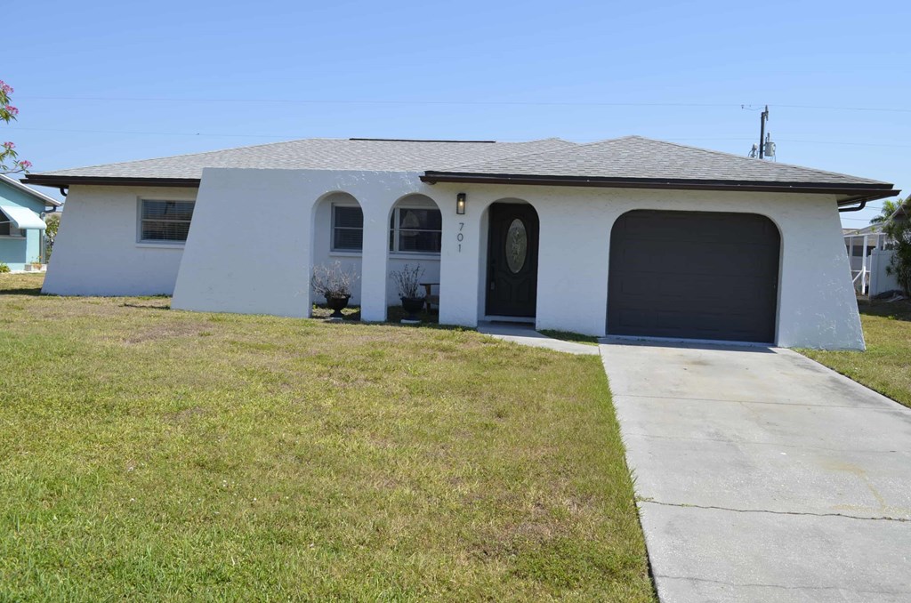 a white house with a driveway and a garage door