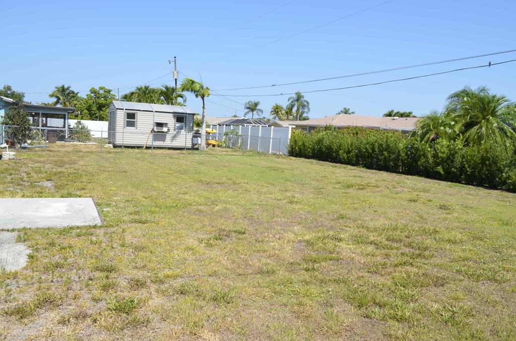 a backyard with a house and a yard with grass