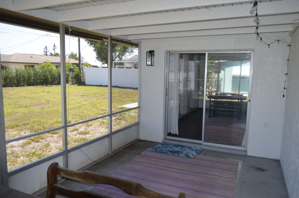 screened in porch with dining room in the background