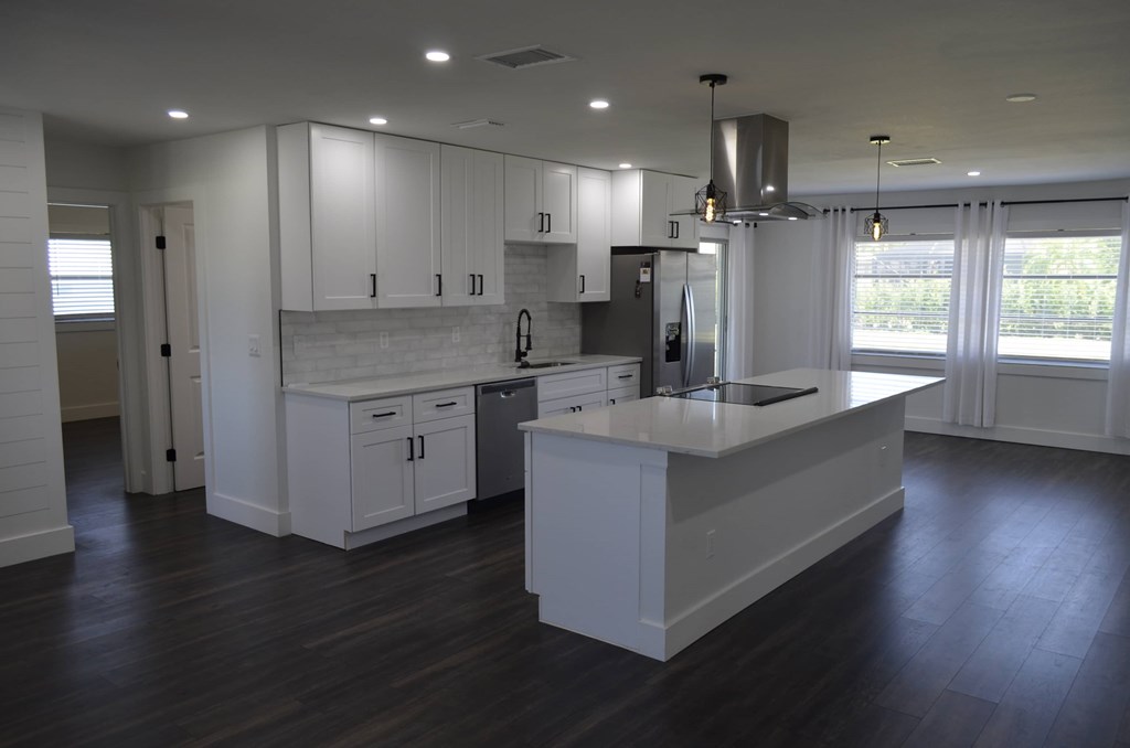 a kitchen with white cabinets and a white counter top