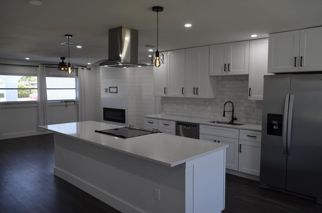 a recent kitchen remodel with white cabinets and stainless steel appliances