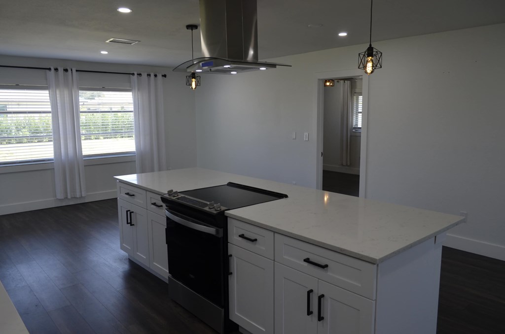 a kitchen with an island and a stove in a house